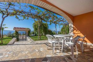 a patio with a table and chairs and a view of the ocean at Apartments in Crikvenica 43070 in Barci