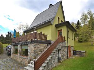 a small yellow and brown house with a staircase at Mountain Hideaway in Wildenthal in Weitersglashütte