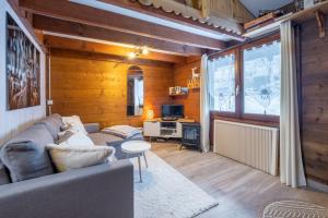 a living room with a couch and a table at Mazot cozy chalet spirit in Chamonix in Chamonix-Mont-Blanc