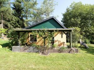 a small house with a green roof in a field at Cozy Escape in Walthersdorf in Scheibenberg +32 photos