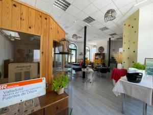 a store with a room with tables and chairs at El Vagón Bar-Albergue Béjar in Béjar