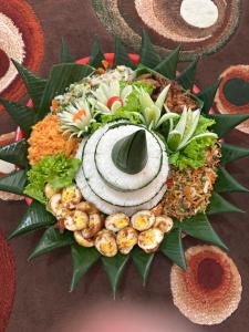 a plate of food with seafood and vegetables on a table at The Beachbreaks Medewi in Airsatang +34 photos