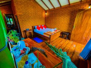 a living room with a bed and a table at Tree Top View Tree House in Sigiriya