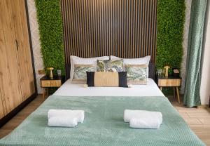 a bedroom with a bed with two pillows on it at Stylish Flat with Free Pool Access, Bendita Mare by Flat Mаnаger in Varna City +15 photos