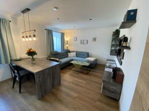 a living room with a couch and a table at Ferienwohnung in Drachselsried für 2 Personen in Drachselsried