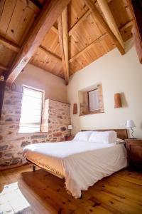 a bedroom with a large bed in a room with wooden ceilings at Casa Somoza in Castrillo De Los Polvazares