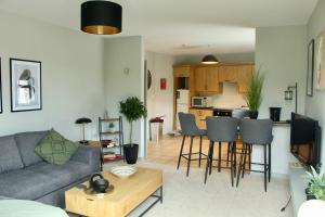 a living room with a couch and a kitchen at Riverside Haven in Ardara in Ardara
