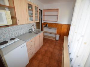 a kitchen with a sink and a counter top at Mountain Retreat with Pool in Hnanice