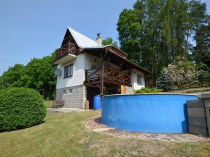 a house with a blue wall in front of it at Mountain Retreat with Pool in Hnanice +24 photos