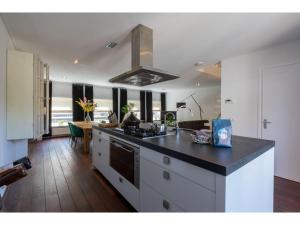 a kitchen with a stove and a counter top at Central Domburg Apartment in Domburg