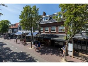 a group of people standing on a street in front of a building at Central Domburg Apartment in Domburg