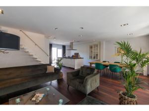 a living room with a couch and a table at Central Domburg Apartment in Domburg