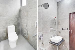 a bathroom with a shower and a toilet and a sink at Super Collection O Iskcon Temple Mansarovar Formerly Chinar Inn in Jaipur