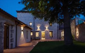 an exterior view of a house at night with lights at Casa Vieja de la Abuela in Fuentesaúco de Fuentidueña