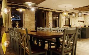 a dining room with a wooden table and chairs at Casa Vieja de la Abuela in Fuentesaúco de Fuentidueña +26 photos