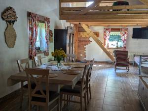 a kitchen and dining room with a table and chairs at Piecówka Wysokie Kaczki in Kaczkowo +37 photos