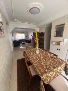 a dining room table with chairs and a living room at Dar Lina in Sale