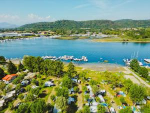 an aerial view of a lake with a group of tents at Lido Verbano Camping Village in Castelletto sopra Ticino
