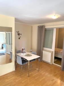 a dining room with a white table and chairs at Apartman Lucija in Gradići