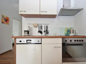 a kitchen with white cabinets and a counter top at Wohnung in Willingen nahe Ettelsberg-Bahn in Willingen
