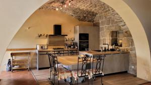 a kitchen with a table and chairs in a room at Gites de france aux badieux in Les Badieux
