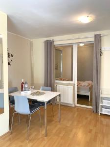 a dining room with a table and chairs and a bedroom at Apartman Lucija in Gradići +16 photos