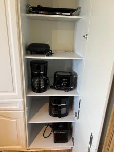 a cupboard with a coffee maker and a toaster at Maison Frieda in Oostkamp