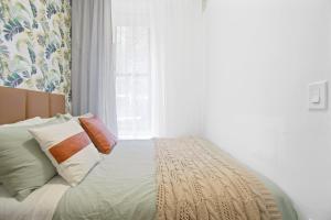 a bedroom with a bed with pillows and a window at Upscale 2BR Home in New York