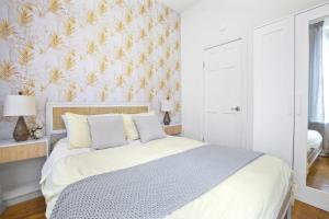a bedroom with a bed with a pineapple wallpaper at Upscale 2BR Home in New York