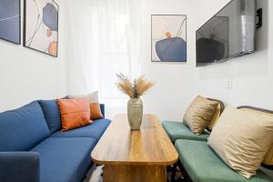 a living room with a couch and a table at Upscale 2BR Home in New York +14 photos