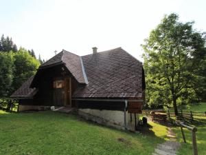 an old house with a brown roof on a field at Chalet in Prebl nahe Klippitztörl Ski in Prebl