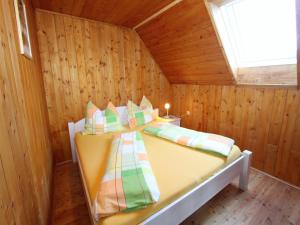 a bedroom with a bed in a wooden room at Chalet in Prebl nahe Klippitztörl Ski in Prebl