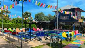 a pool at the resort with colorful chairs and flags at WET Pool Party Haad Rin in Haad Rin
