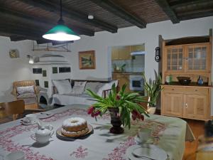 a living room with a table with a cake on it at Ferienhaus in Kollnburg mit Garten in Achslach