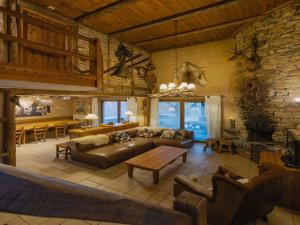 a living room with a couch and a table at Chalet Retreat with Sauna in Robertville