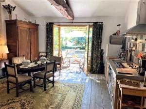 a kitchen with a table and a dining room at Cottage in Saint-Jean with Terrace in Frontenay-sur-Dive +20 photos