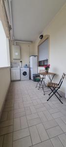 a large kitchen with a table and a refrigerator at Dimora Speranza in San Giovanni Teatino +3 photos