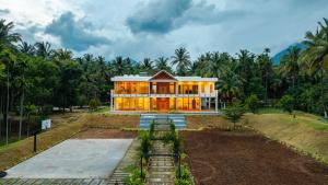 a house in the middle of a forest at Punya Farms - Luxury 5BR near Isha Yoga in Alāndurai