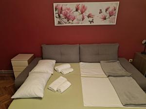 a bed with two pillows on it in a room at LuMiDo in Osijek