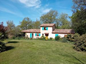 a large white house with a yard at Chez Mamie in Cazes-Mondenard