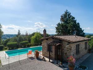 a villa with a pool in front of a house at Charming Retreat in Armaiolo in Rapolano Terme +32 photos