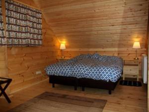 a bedroom with a bed in a wooden cabin at Ferienhaus, Wissinghausen in Medebach +11 photos