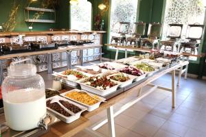 a buffet line with many different dishes of food at Almog Hotel in Almog