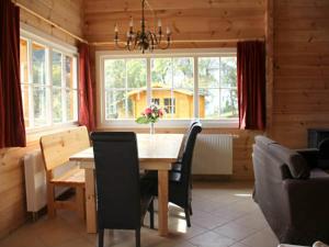 a dining room with a wooden table and chairs at Ferienhaus, Wissinghausen in Medebach