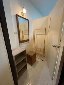 a bathroom with a mirror and a sink and a mirror at Sairin 1 bedroom BTS Udomsuk in Bangna +19 photos