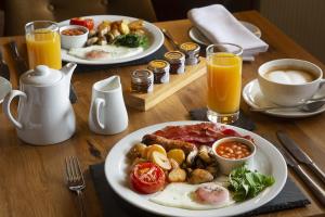 two plates of breakfast food on a wooden table at Hill Farm in Oxford +7 photos