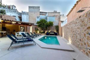 a patio with chairs and a swimming pool at Horta 55 in Pollença