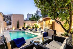 a swimming pool with lounge chairs at Horta 55 in Pollença