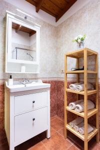 a bathroom with a sink and a mirror at OkStay - Casa Canaria en El Sauzal in Tacoronte +25 photos