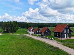 a group of houses in a field with a road at Suwalskie Klimaty in Kaletnik